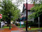 Shop shady tree-lined street in Niltmore Village