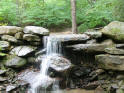 Cozy cabin rental with waterfall and hot tub