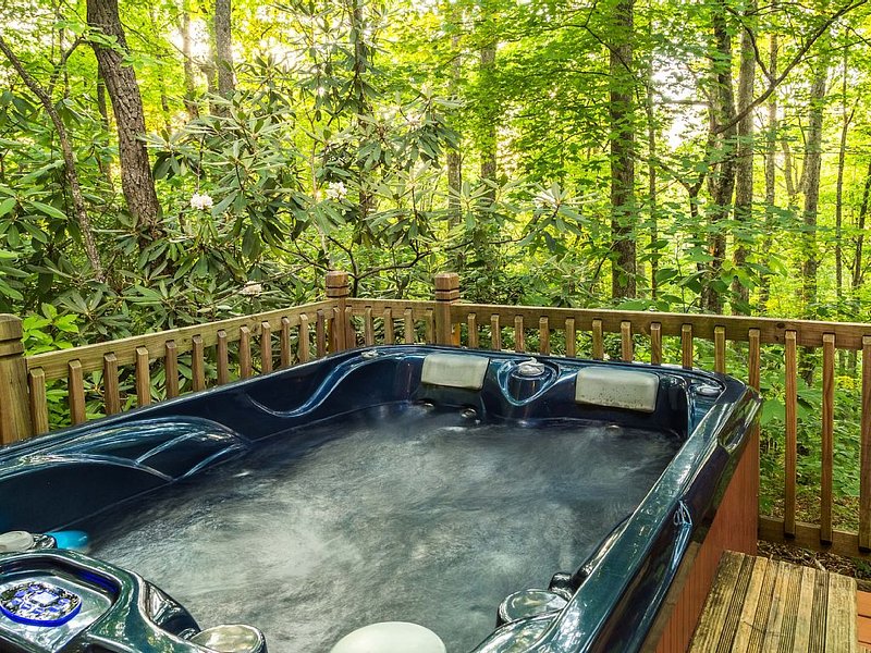 Cabin rental in a wooded setting with mountain views and hot tub